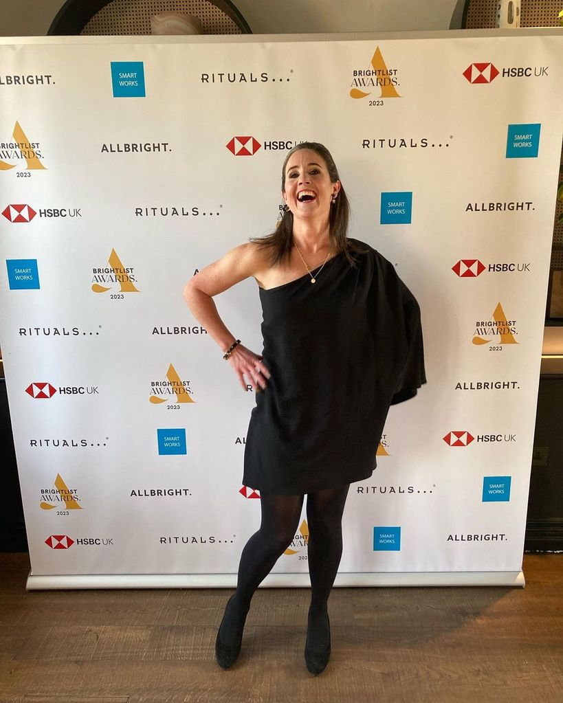 Laughing woman in a one shoulder black dress