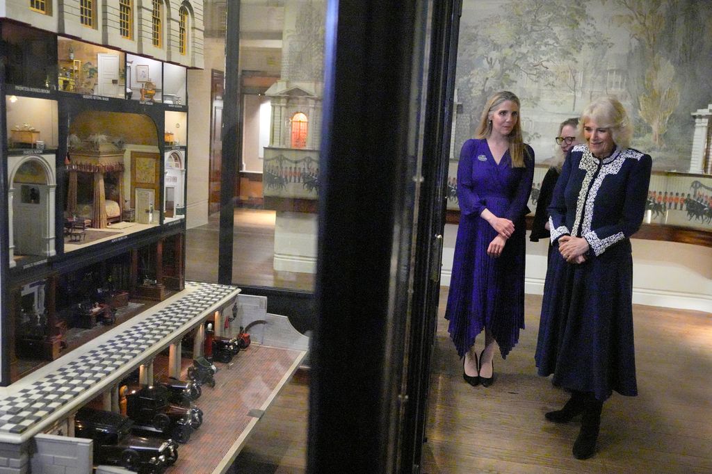 Queen Camilla looking at Queen Mary's Dolls' House 