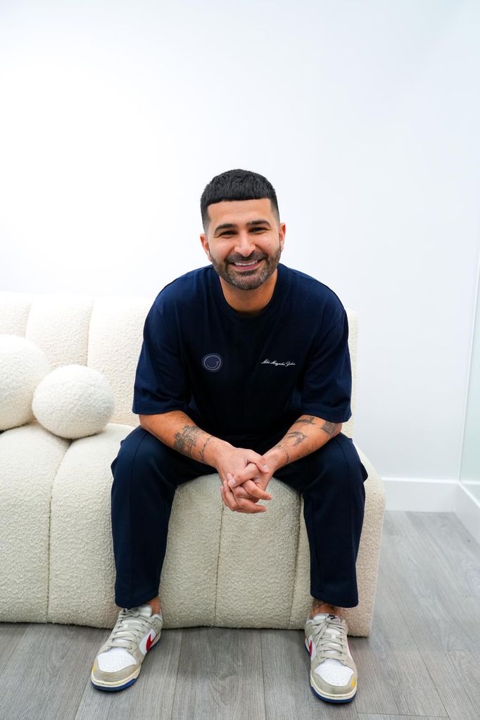 dentist sitting on a white boucle sofa 