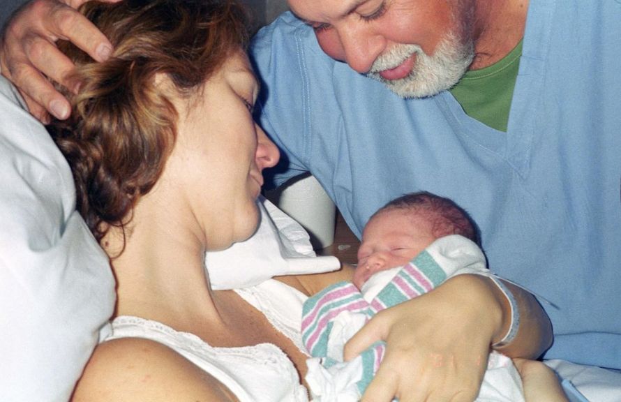 Two parents with a newborn baby