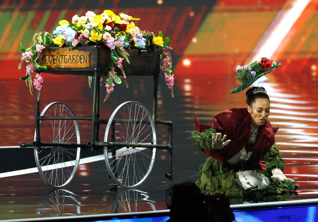 Miss Great Britain Danielle Latimer falls as she competes in the Miss Universe 2025 national costume competition