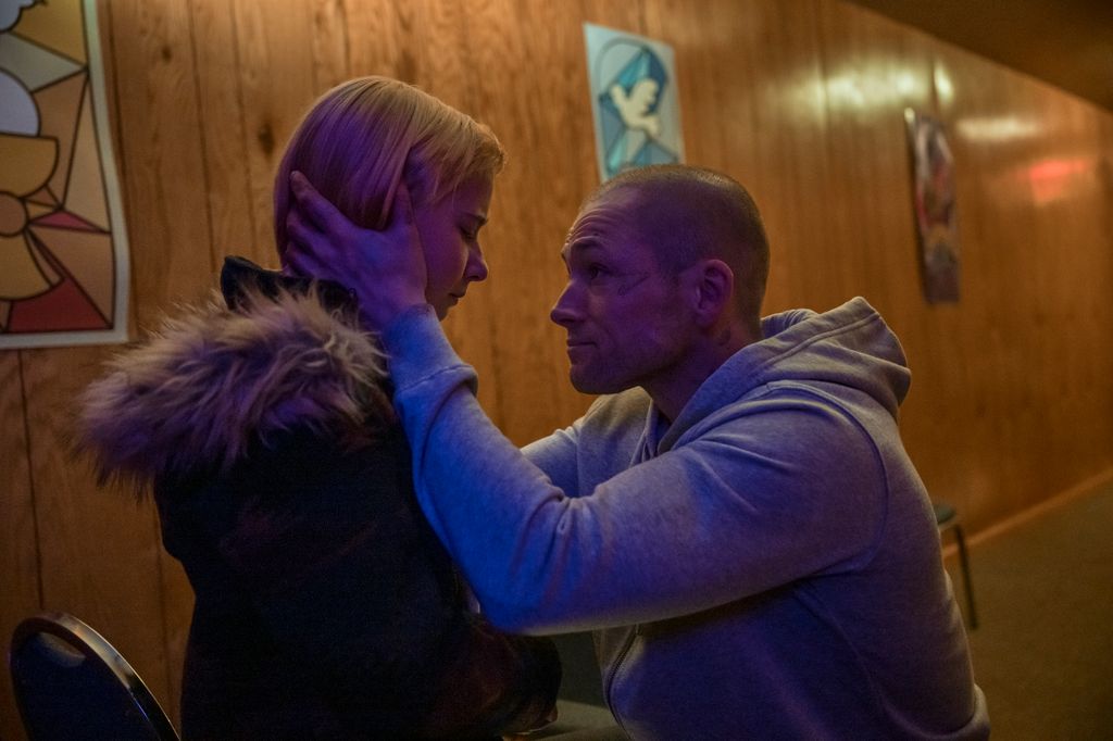 A man holds his daughter's face in his hands