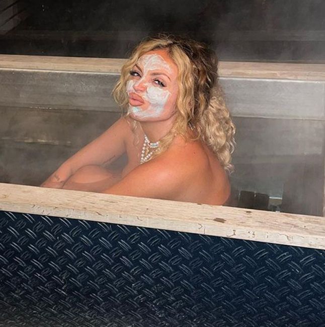 jesy sits naked in a bathtub and pouts playfully