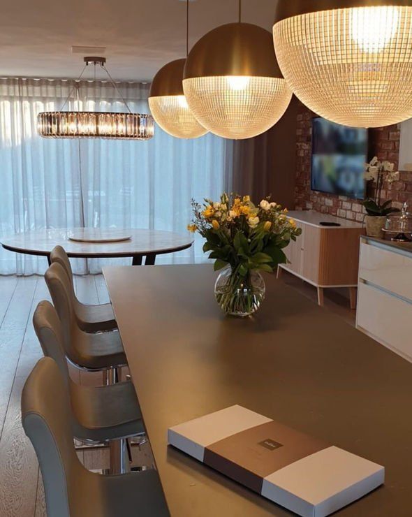 amanda holden dining room with grey table mirrorball pendant lights