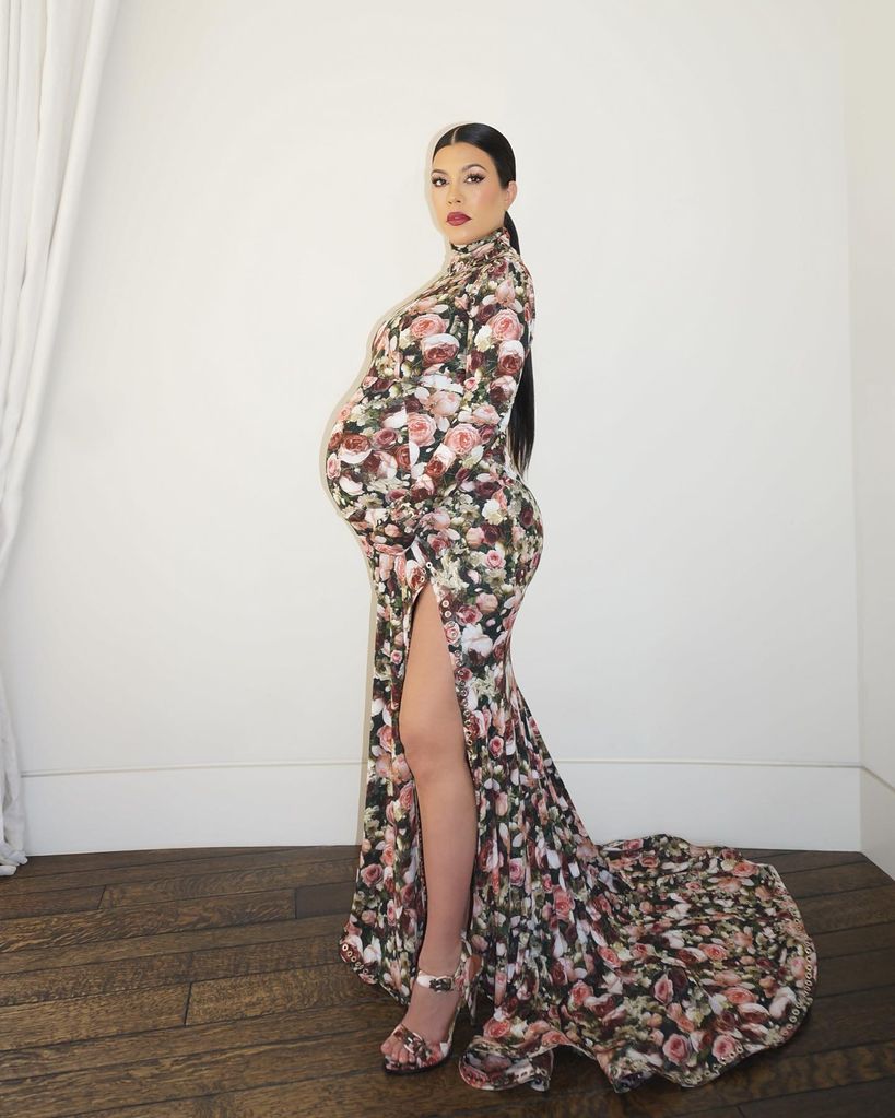 Kourtney Kardashian wears a floral dress while heavily pregnant