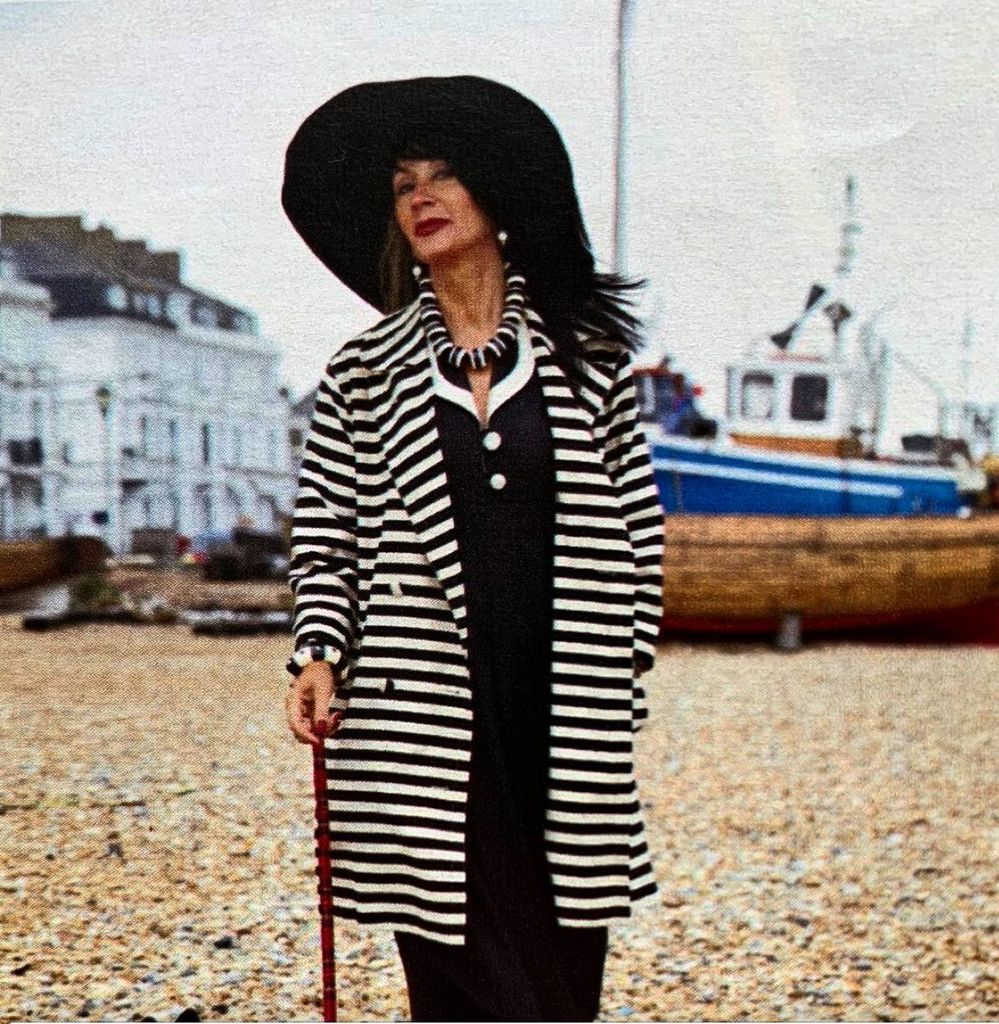 Woman in striped coat on the beach