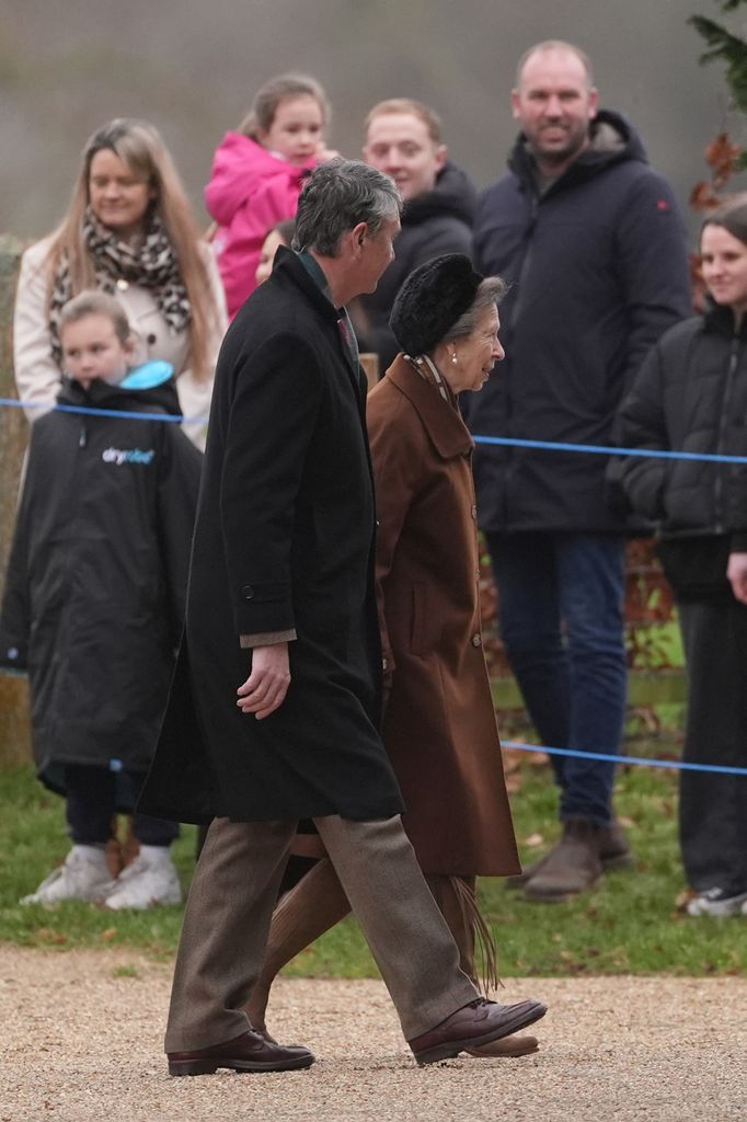 The Princess Royal and her husband Vice Admiral Sir Tim Laurence in coats walking outside