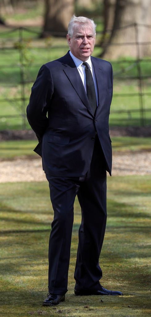 Prince Andrew in a blue suit standing outside