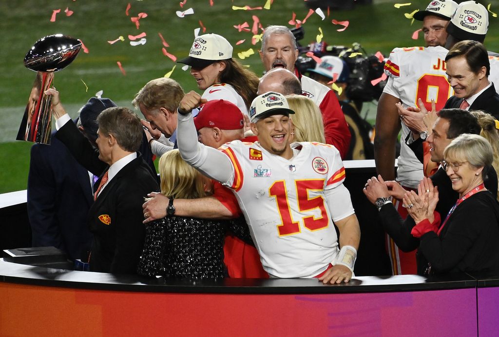 GLENDALE, ARIZONA - FEBRUARY 12: Head coach Andy Reid and quarter back Patrick Mahomes #15 of the Kansas City Chiefs stands on the podium with owner Clark Hunt celebrating with the Lombardi Trophy after they defeated the Philadelphia Eagles 38-35 in Super Bowl LVII at State Farm Stadium on February 12, 2023 in Glendale, Arizona. (Photo by Focus on Sport/Getty Images)