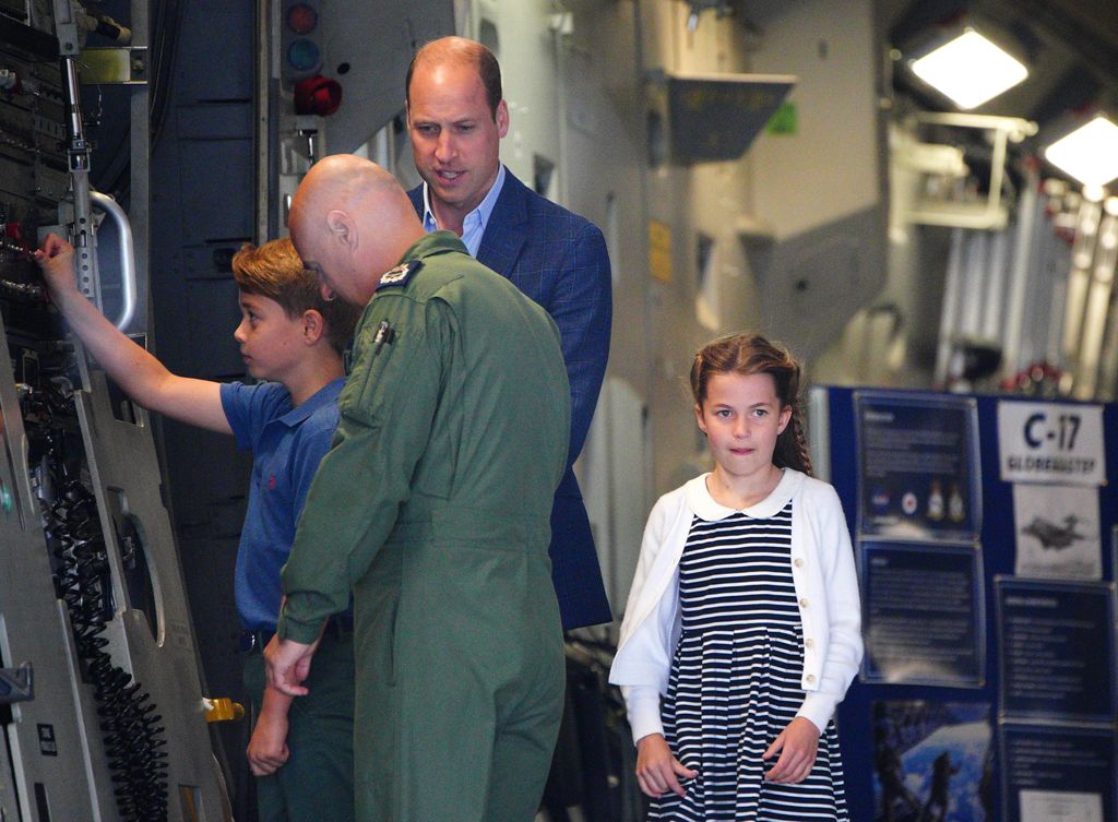 Prince George tries his hand at raising the ramp on the plane