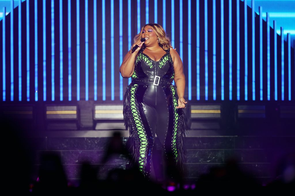Lizzo wears leather catsuit with neon green detailing to perform at Qudos Bank Arena in Sydney 