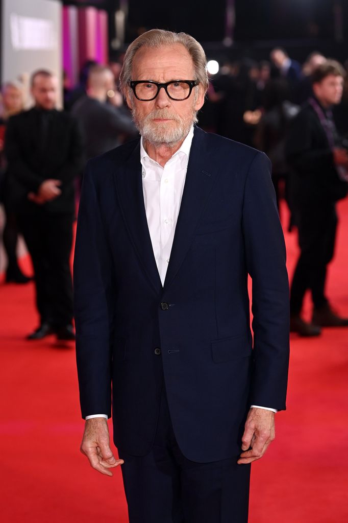 man posing for photo on red carpet
