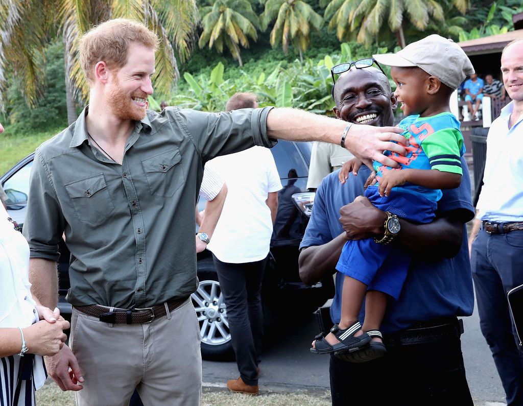 Prince Harry meets a young boy called Jyasi Junior as he visits a Turtle Conservation Project on the seventh day of an official visit to the Caribbean on November 26, 2016 in Colonarie, Saint Vincent and the Grenadines.