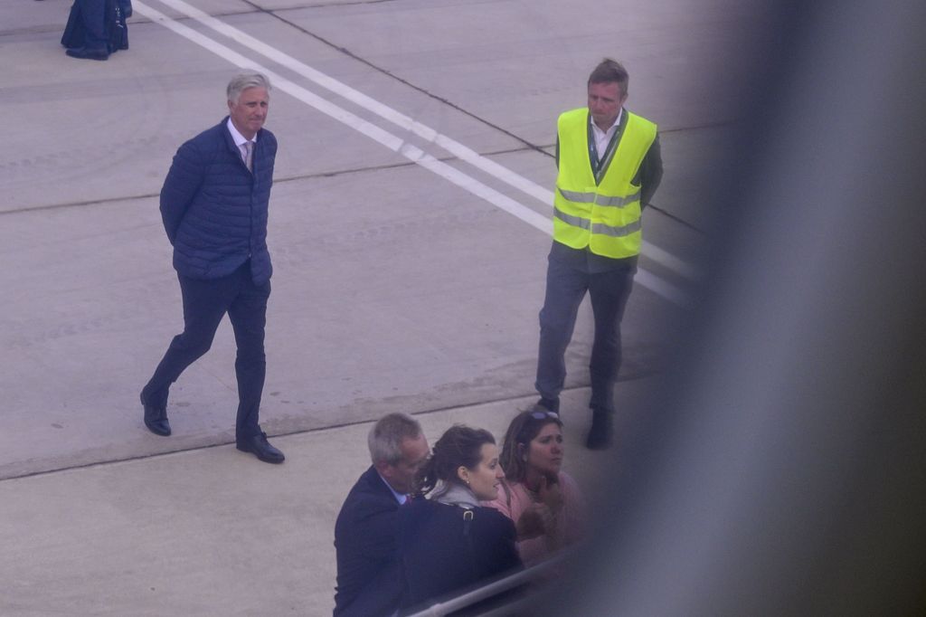 King Philippe regarde un avion sur l'aéroport Tarmac