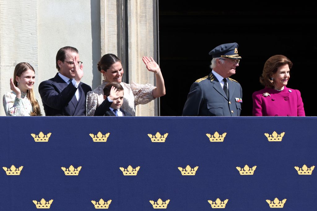 Princess Estelle of Sweden, Prince Daniel, Victoria, Crown Princess of Sweden, Prince Oscar of Sweden, Carl XVI Gustaf, King of Sweden and Queen Silvia of Sweden wave from balcony