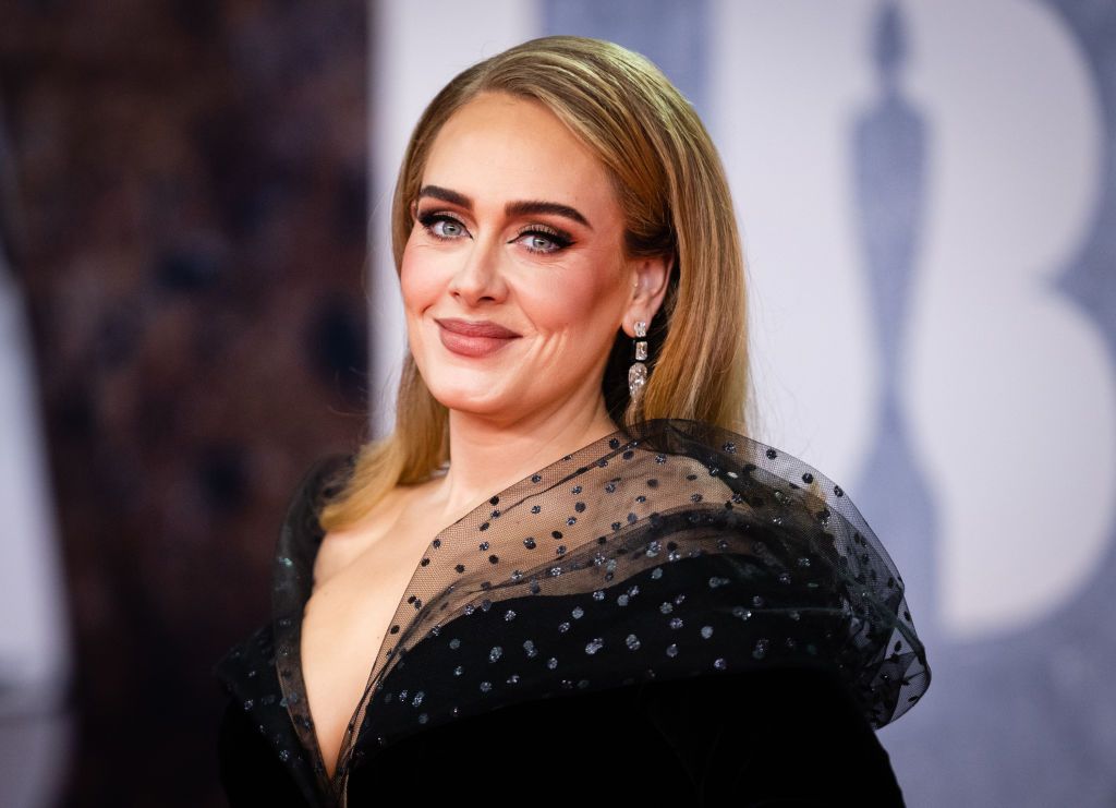 Close up of Adele at the 2022 BRIT Awards. She is wearing a black evening gown