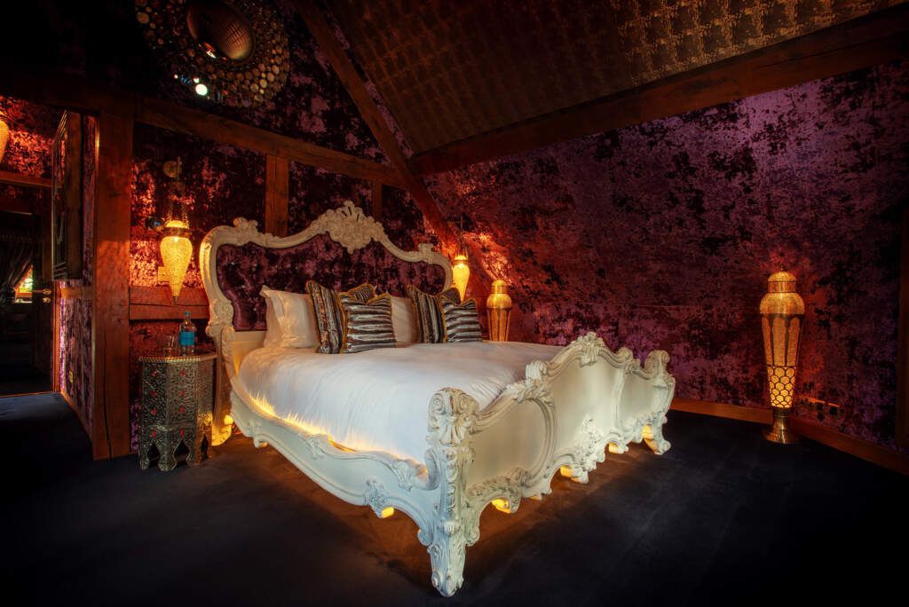 Giant bed in a velvet-covered room