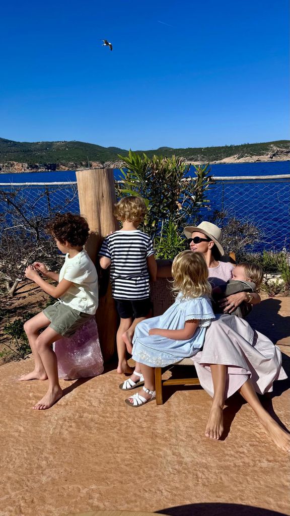 woman with four children on the coast