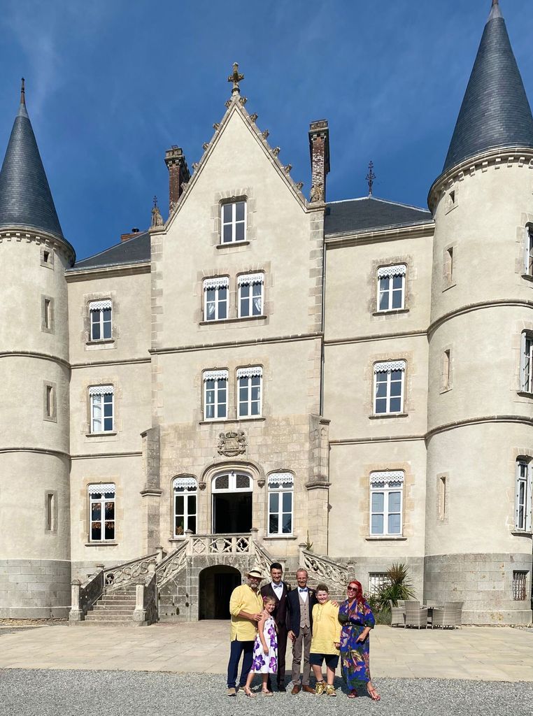 The Strawbridge family standing outside the Château de la Motte-Husson