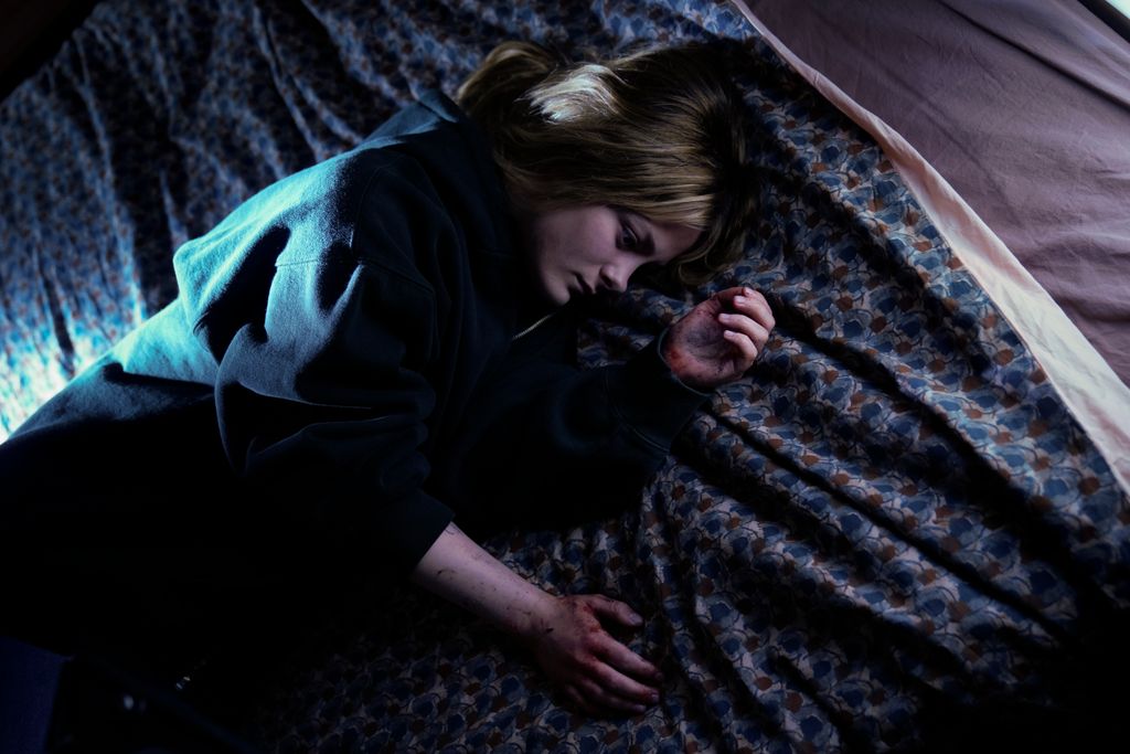 teen girl lying on bed