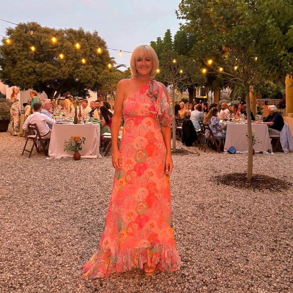 Jane Moore in a one-shouldered floral dres