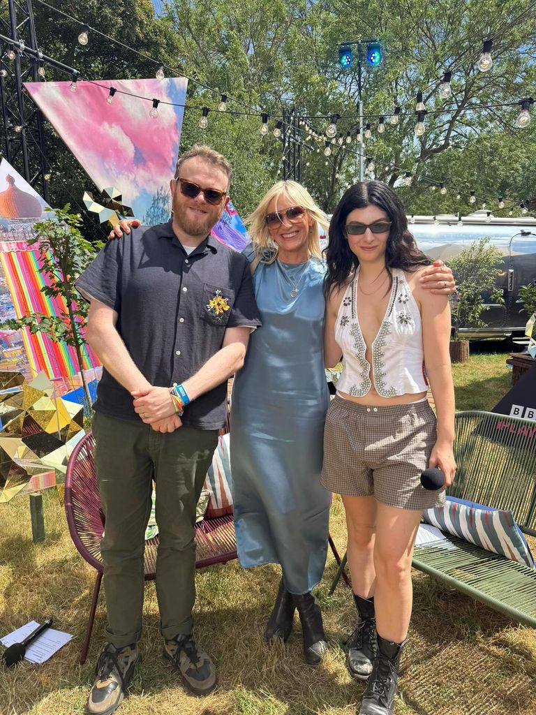 jo whiley in blue dress posed with Lorde and huw stephens