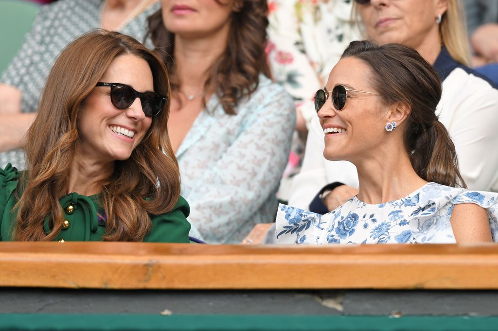 Kate Middleton smiling towards Pippa Middleton