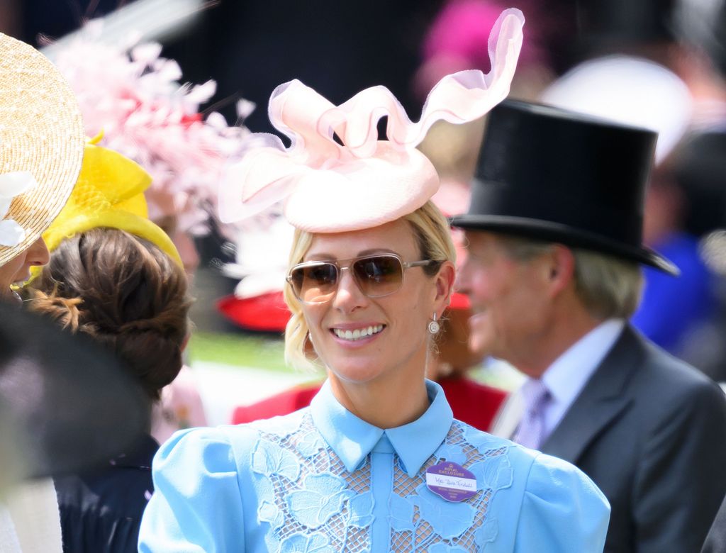 Zara Tindall wearing a blue dress and pink fascinator