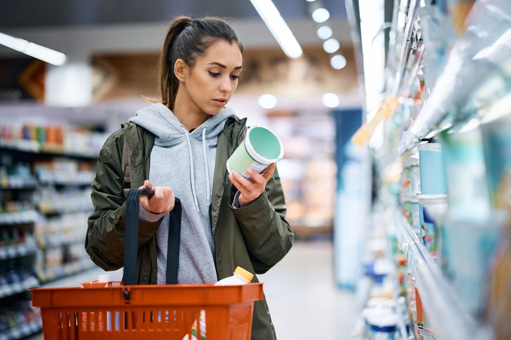 woman reading product package label for harmful ingredients