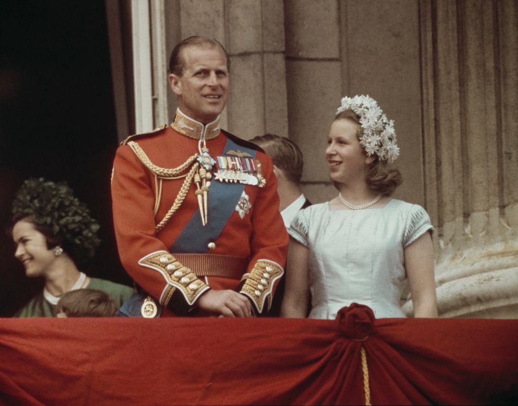 young Princess Anne on balcony beside prince philip in uniform