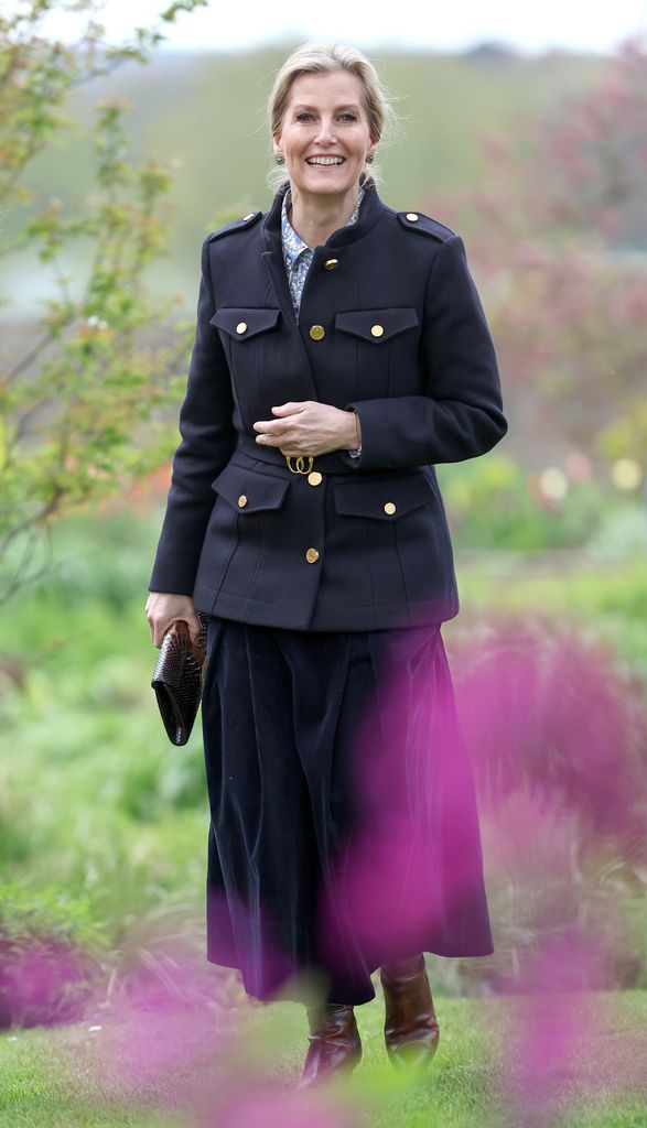 Sophie, Duchess Of Edinburgh smiles in navy jacket and skirt