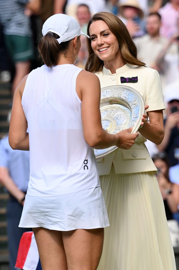 Catherine, Princess of Wales presents the winner's trophy to Iga Swiatek on day thirteen of the Wimbledon Tennis Championships at the All England Lawn Tennis and Croquet Club at All England Lawn Tennis and Croquet Club on July 12, 2025 
