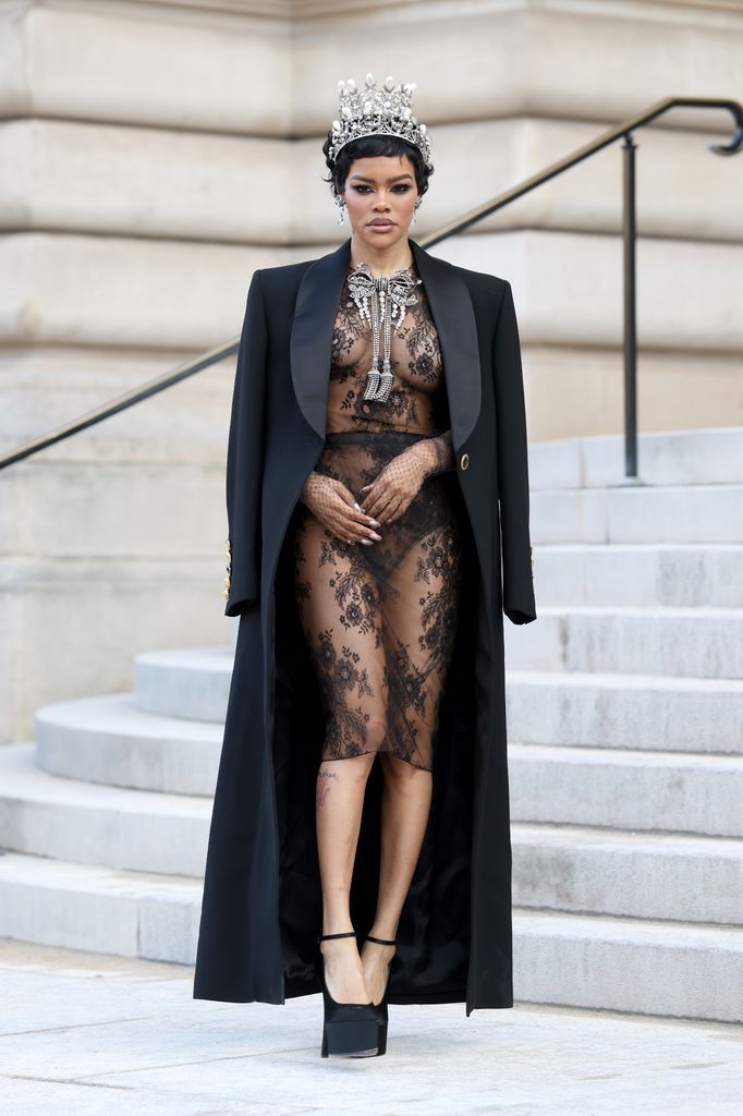 Teyana Taylor wearing a sheer lace dress and black coat at the Schiaparelli Haute Couture Week Spring/Summer 2026 show
