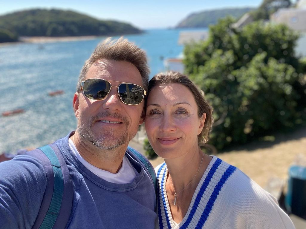 couple posing by sea 