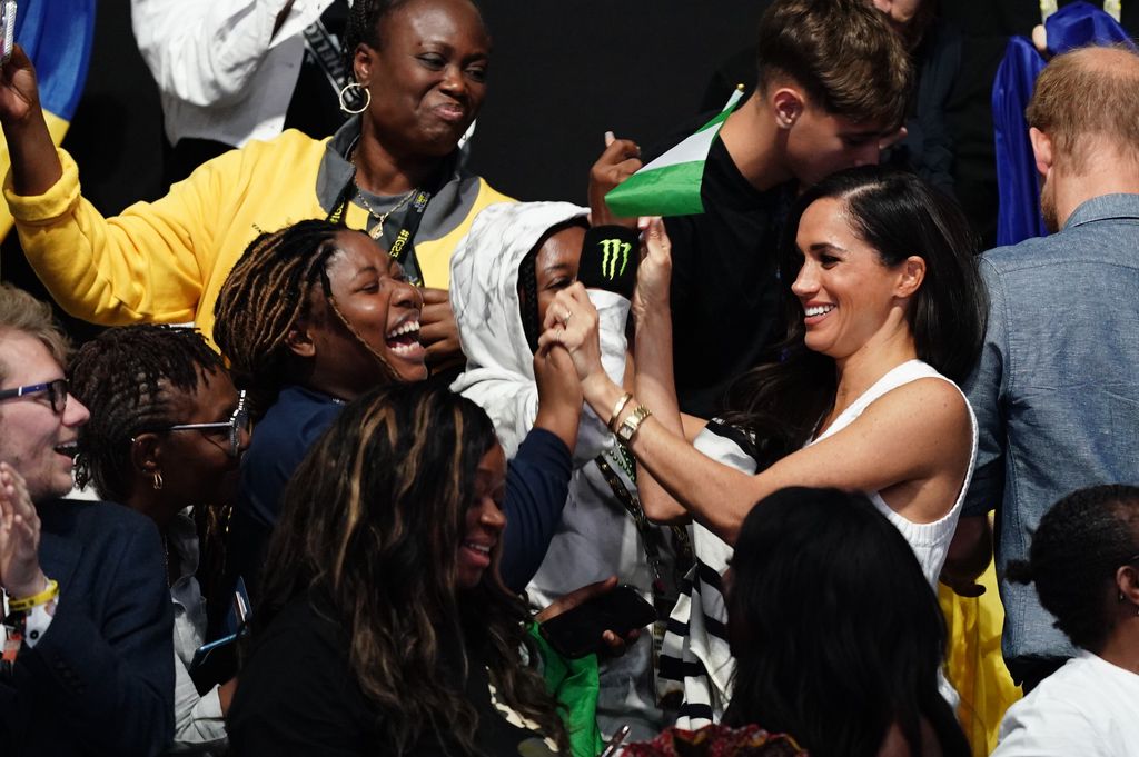 The Duchess of Sussex talks with fans during the sitting volleyball competition