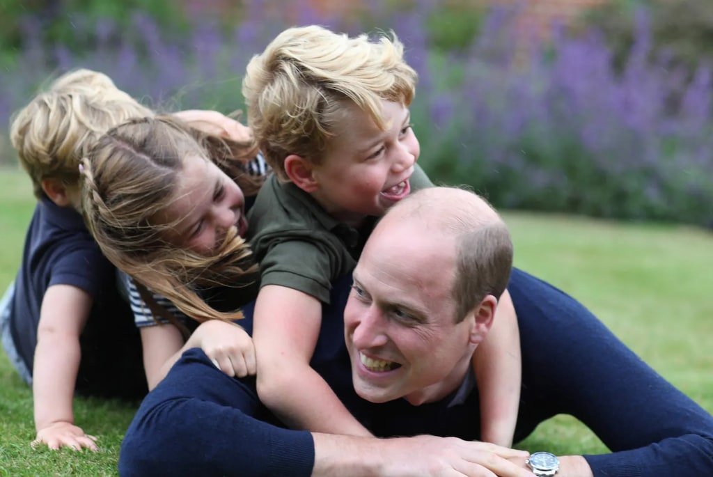 prince william lying on the grass with kids