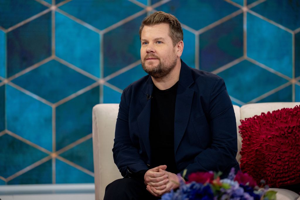James Corden sitting on a cream sofa looking at camera while filming TODAY on NBC