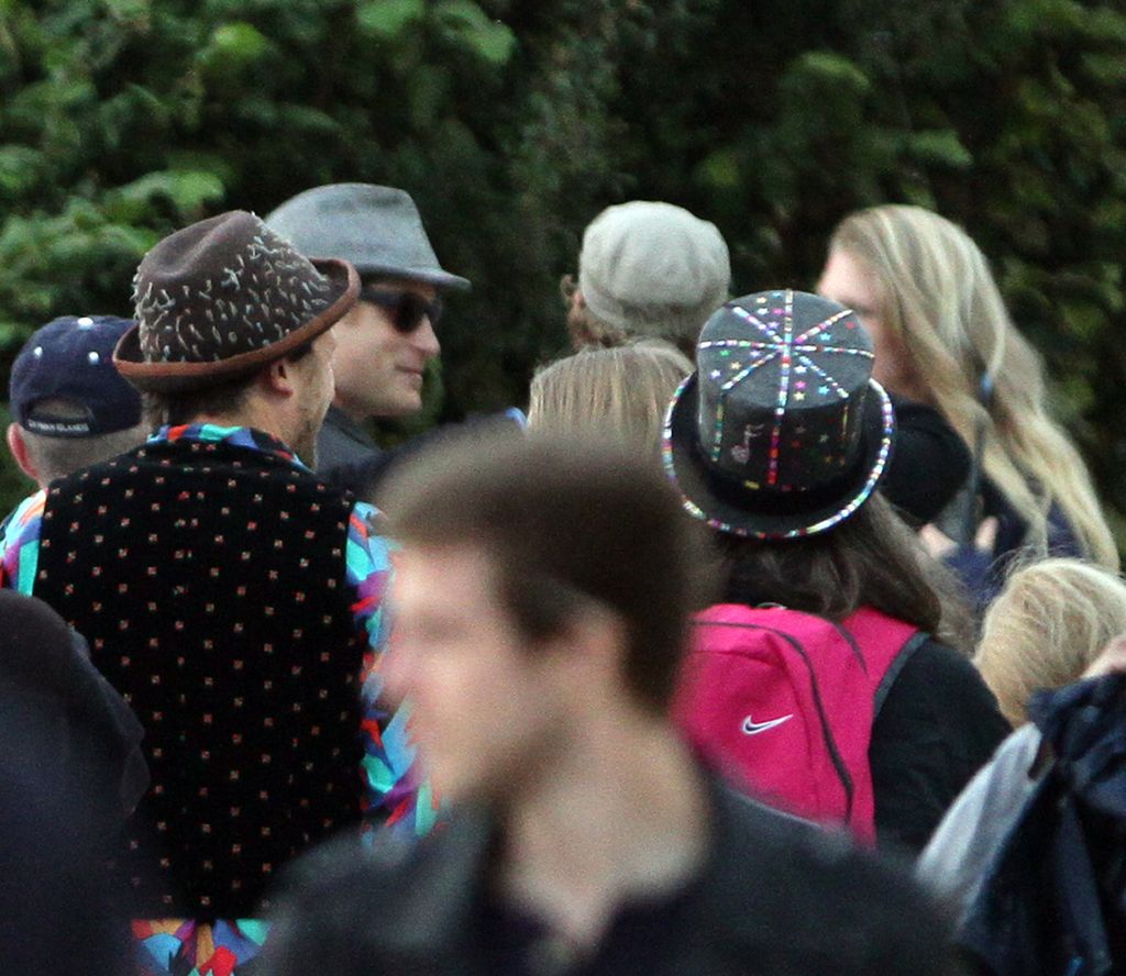 Prince Harry, in a grey trilby hat, backstage during the second day of the Glastonbury 2013 Festival