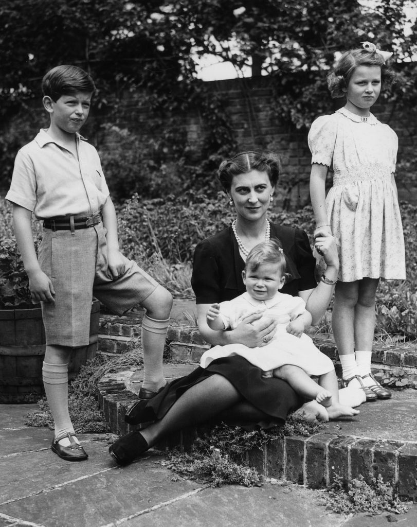 Black-and-white photo of the young Duke of Kent with Princess Alexandra, Prince Michael of Kent and their mother, Marina, Duchess of Kent
