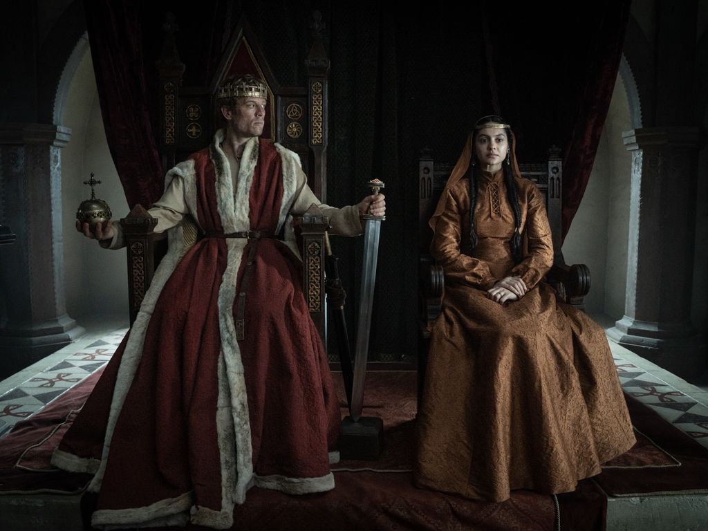 king and queen sitting on thrones