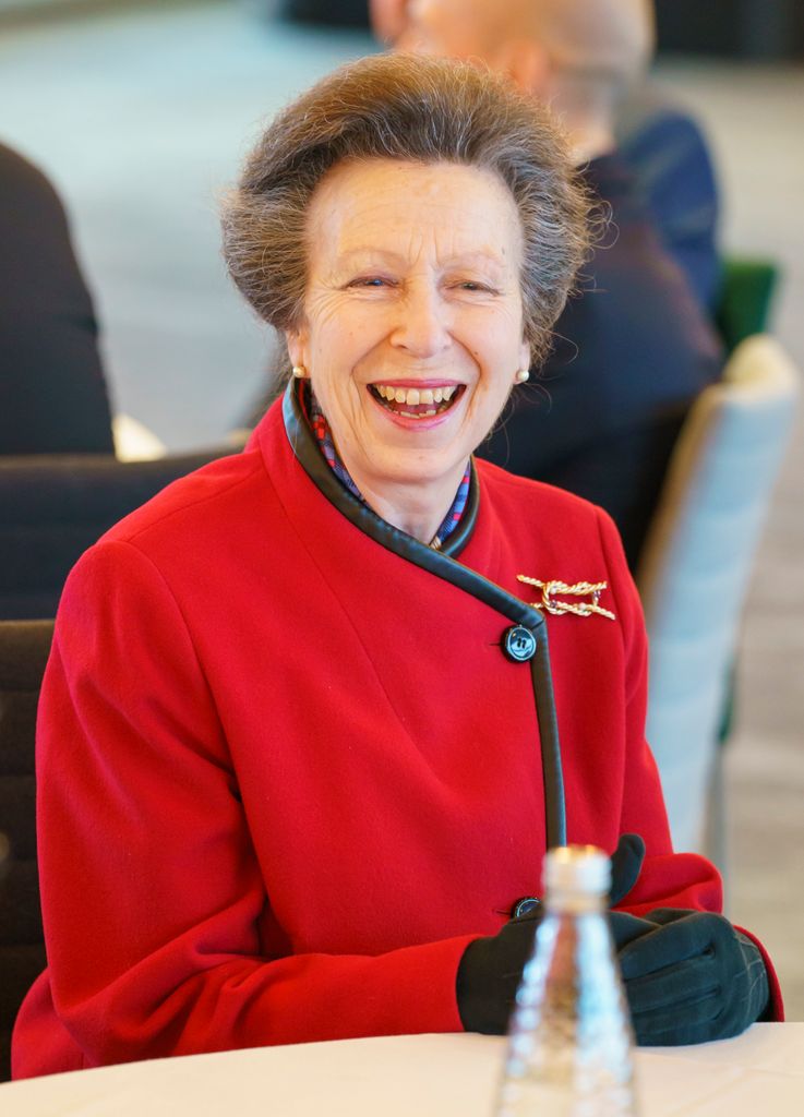 Princess Anne wearing red coat and smiling