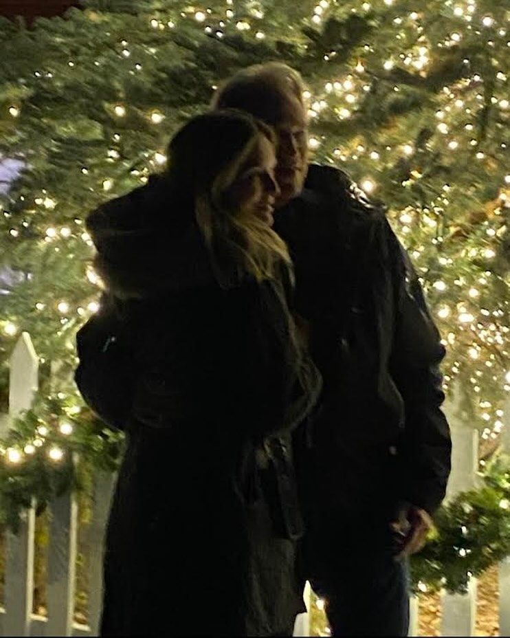 Michelle Pfeiffer and husband David E. Kelley captured in a photo shared on Instagram beside a Christmas tree