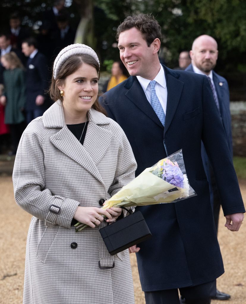 Princess Eugenie holding a bouquet of flowers walking with Jack Brooksbank