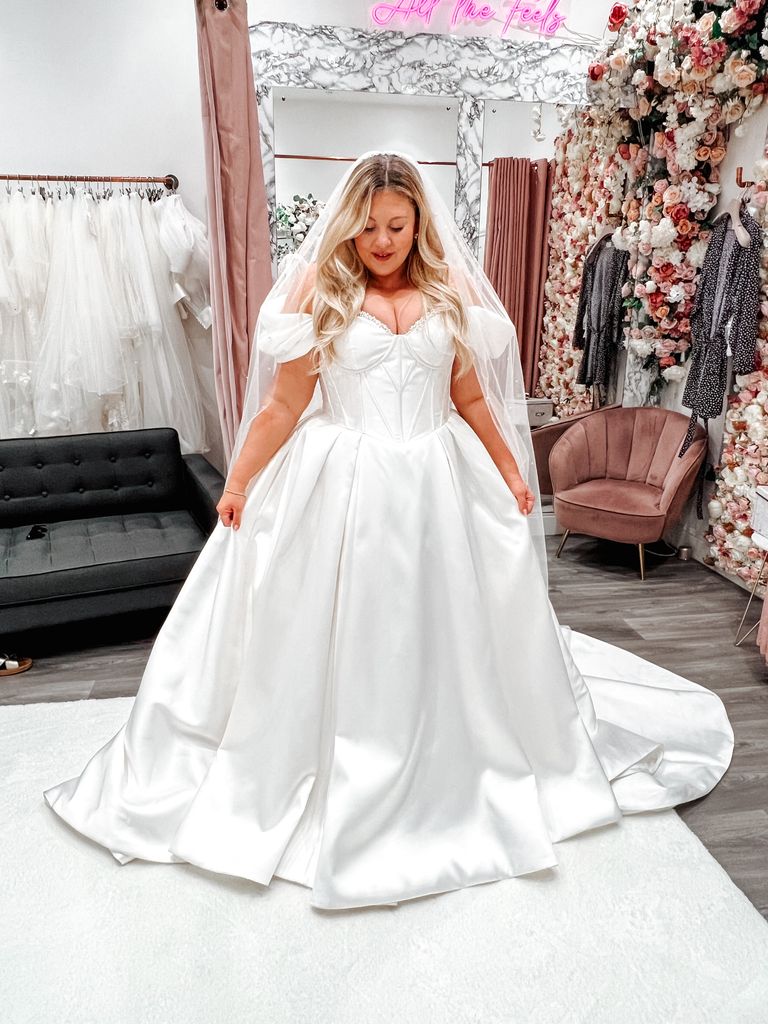 Woman in a white dress in a wedding dress shop