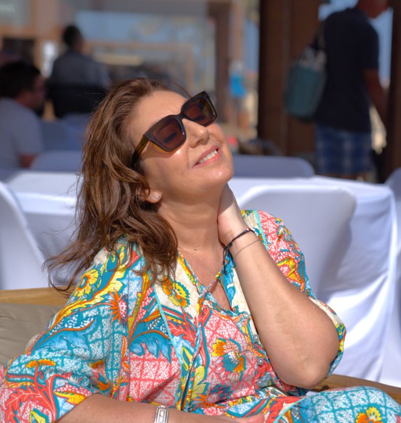 Jane McDonald in sunglasses with bright coloured dress