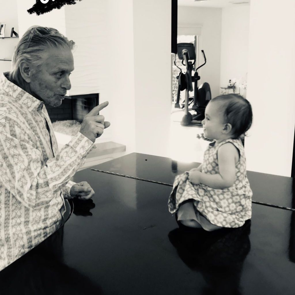 Michael pointing at baby granddaughter