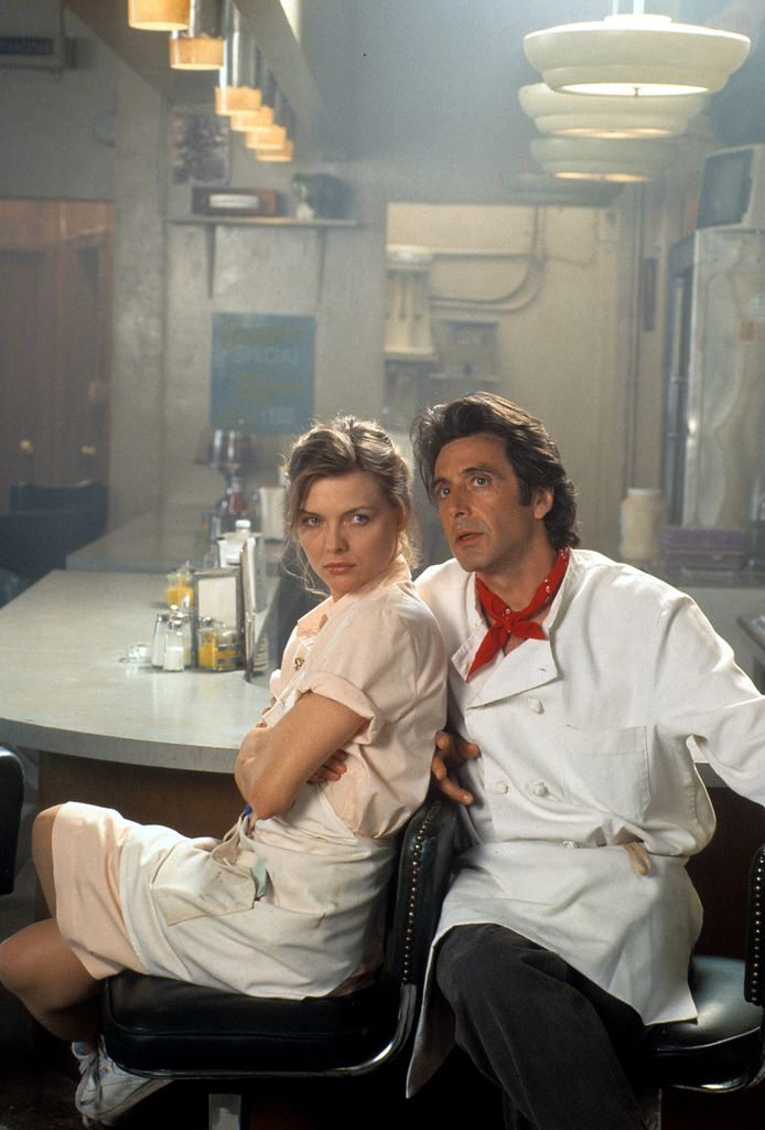 Michelle Pfeiffer and Al Pacino sitting in diner in publicity portrait for the film 'Frankie And Johnny', 1991