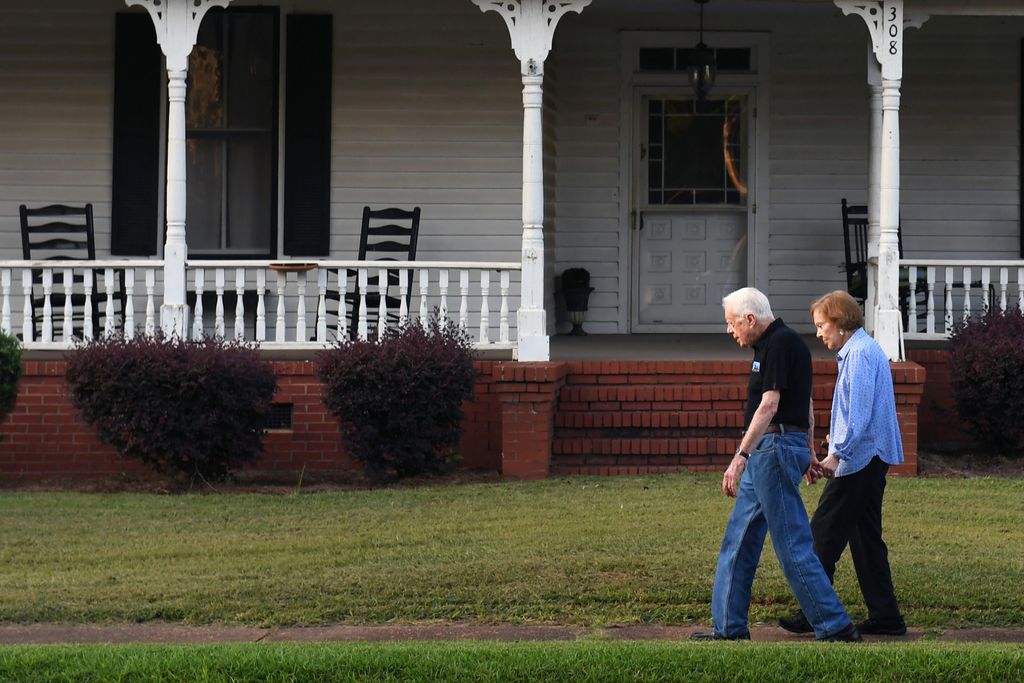 Jimmy Carter walks with his wife Rosalynn Carter in Plains, GA in 2018