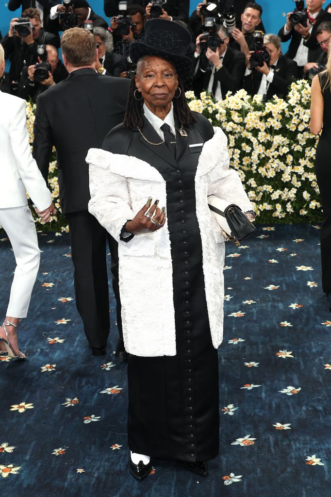 Whoopi Goldberg wears a black and white ensemble plus top hat and brogues. 