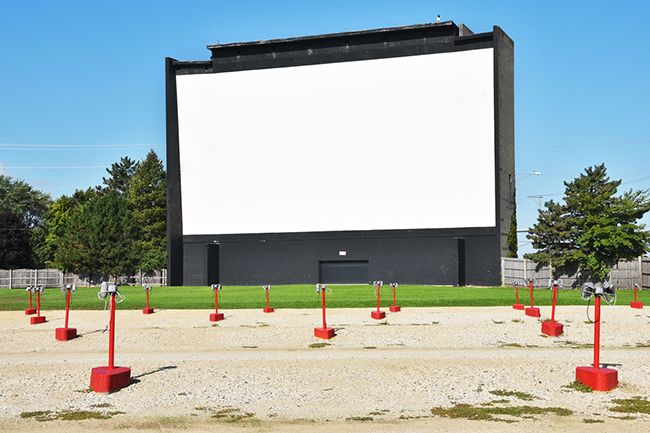 A big screen in front of a parking area